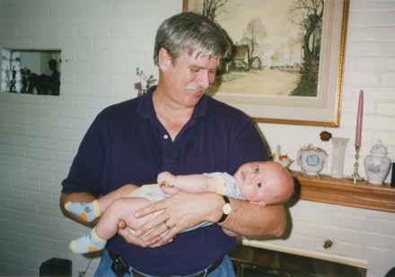 Don and baby Sean by the fireplace